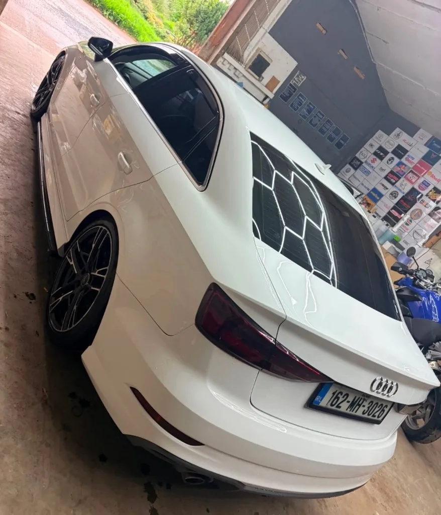 White Audi sedan after detailing in workshop